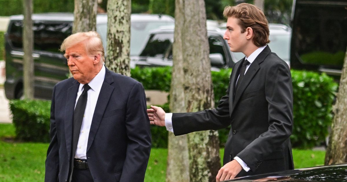 Former President Donald Trump is seen with his son Barron Trump in a file photo from January. Barron Trump turned 18 Wednesday.
