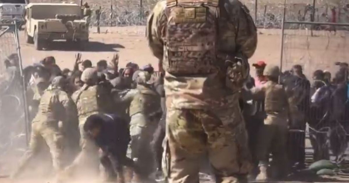 Texas National Guard members are seen being overrun by illegal immigrants trying to force their way across the southern border at El Paso, Texas.