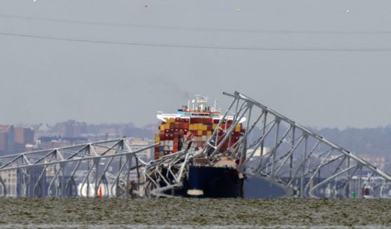 A container ship rests against wreckage of the Francis Scott Key Bridge in Baltimore, Maryland, on March 26.