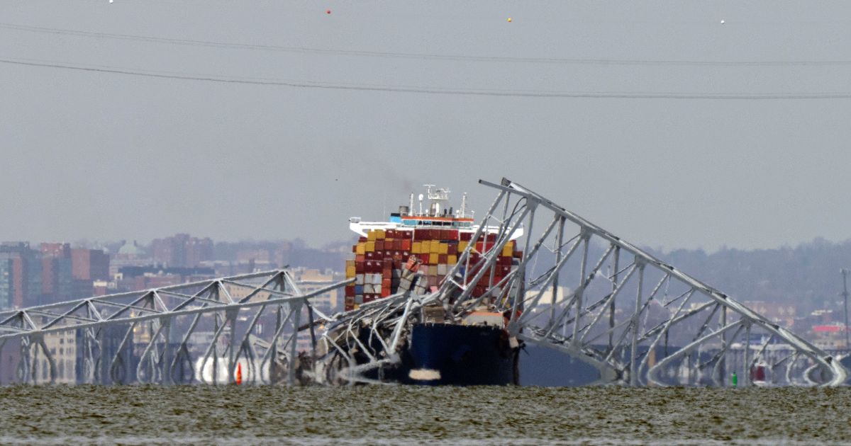 A container ship rests against wreckage of the Francis Scott Key Bridge in Baltimore, Maryland, on March 26.