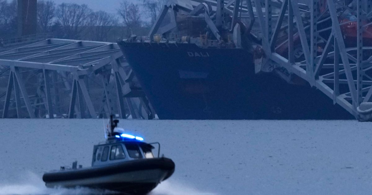 The cargo ship Dali is covered in the wreckage of the collapsed Francis Scott Key Bridge in Baltimore, Maryland, on Tuesday.