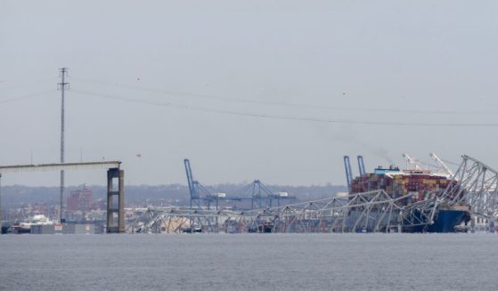 The cargo ship Dali is pictured under the remains of the Francis Scott Key Bridge in Baltimore, Maryland, after colliding with it early Tuesday morning.