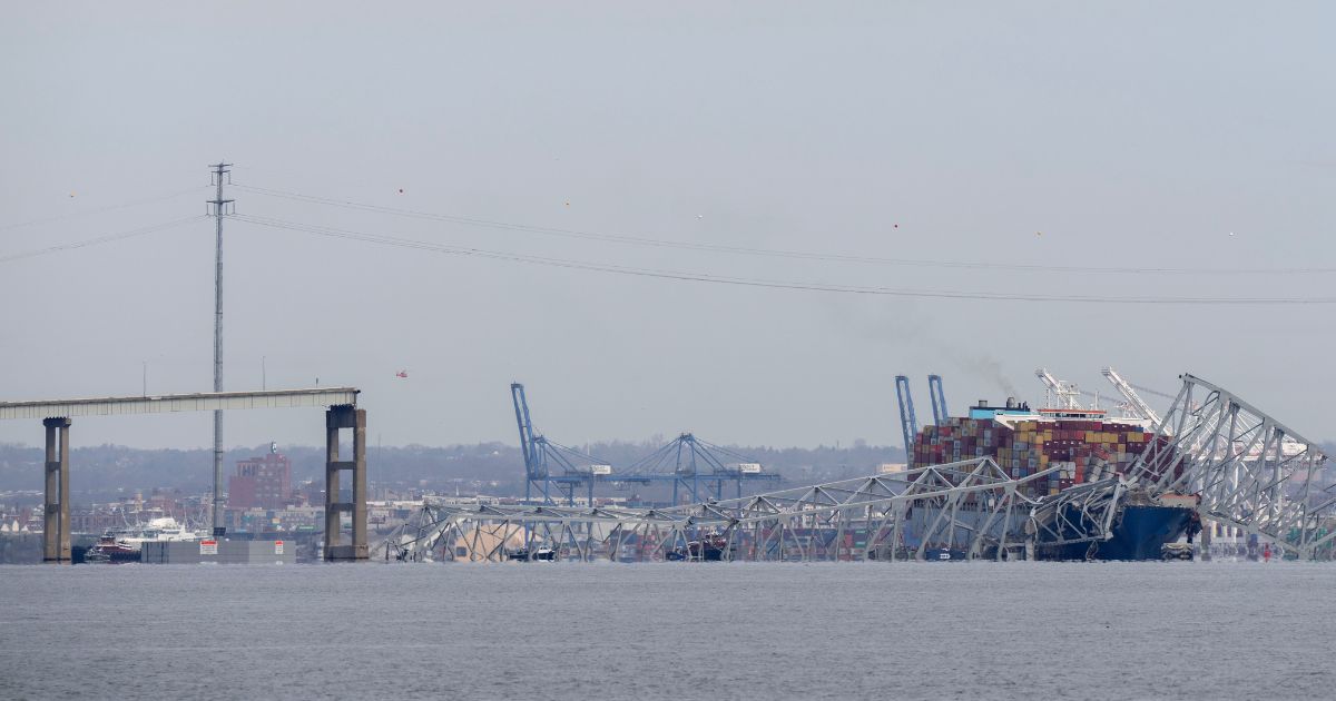 The cargo ship Dali is pictured under the remains of the Francis Scott Key Bridge in Baltimore, Maryland, after colliding with it on March 26.