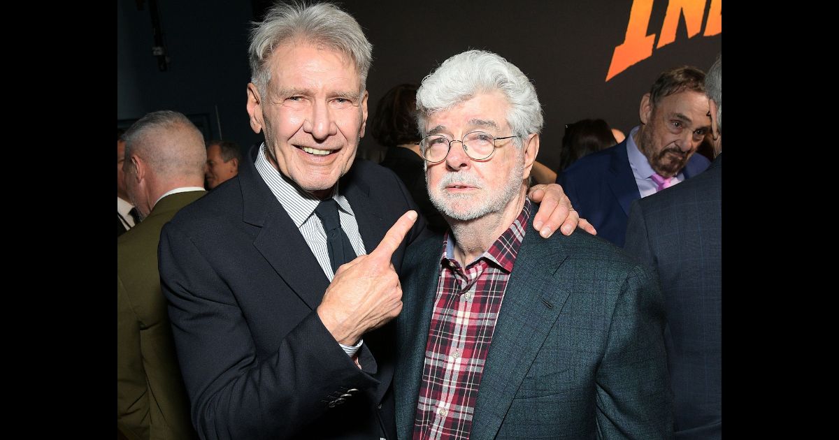 Star Wars creator George Lucas pictured next to movie star Harrison Ford at the premiere of "Indiana Jones and the Dial of Destiny."