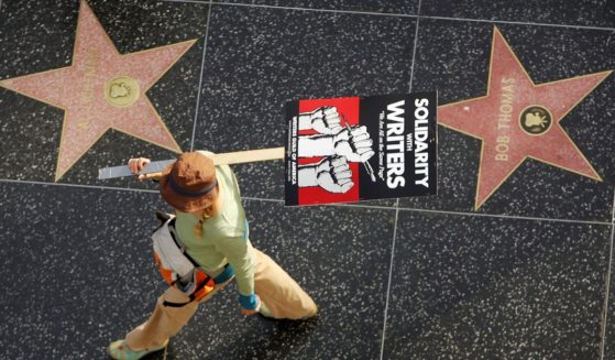 A member of the Hollywood writers' strike walking past the Hollywood Walk of Fame in 2007.