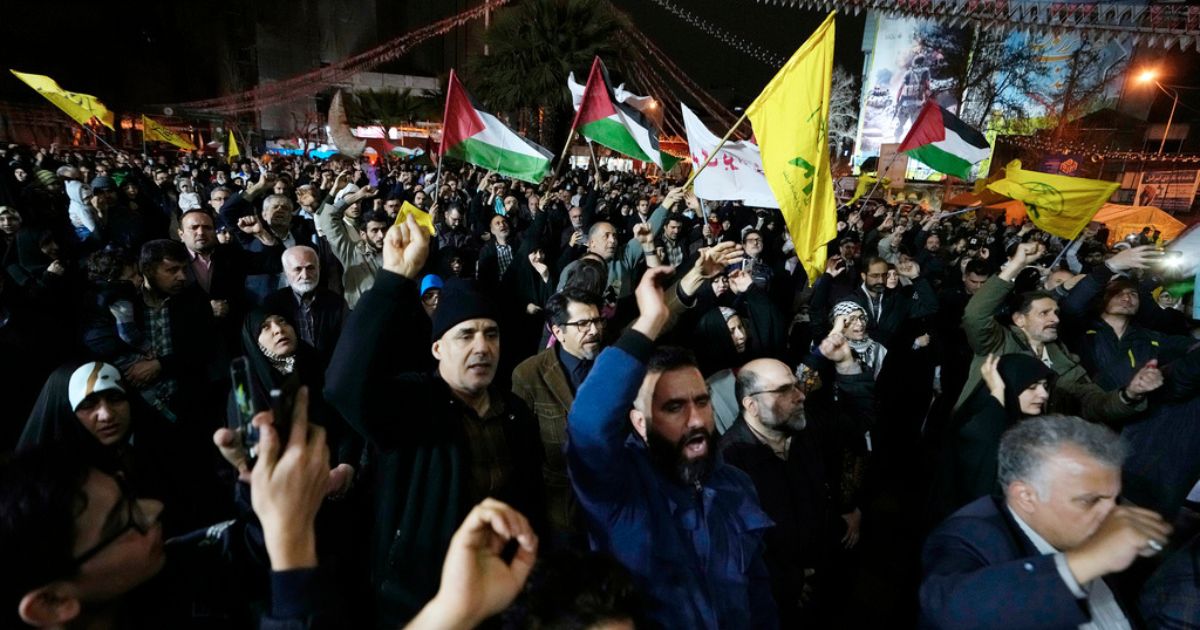 Iranian protesters chant slogans as some of them wave Palestinian flags during an anti-Israeli demonstration Sunday in downtown Tehran, Iran.