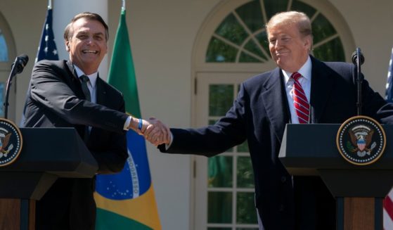 Then-President Donald Trump and Then-Brazilian President Jair Bolsonaro shake hands during a joint news conference in the Rose Garden at the White House in Washington on March 19, 2019.