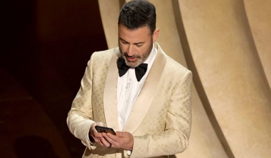 Jimmy Kimmel reads a Truth Social post by former President Donald Trump during the Academy Awards on Sunday.