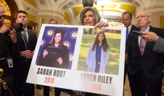 Sen. Joni Ernst, R-Iowa, holds a poster with photos of murder victims Sarah Root and Laken Riley as she speaks on Capitol Hill, Feb. 27 in Washington. House Republicans have passed a bill that would require federal authorities to detain unauthorized immigrants who have been accused of theft, seizing on the recent death of Riley, a nursing student in Georgia. The bill sent a rebuke to President Joe Biden’s border policies just hours ahead of his State of the Union address. However, the nine-page bill had little chance of being taken up in the Democratic-controlled Senate.