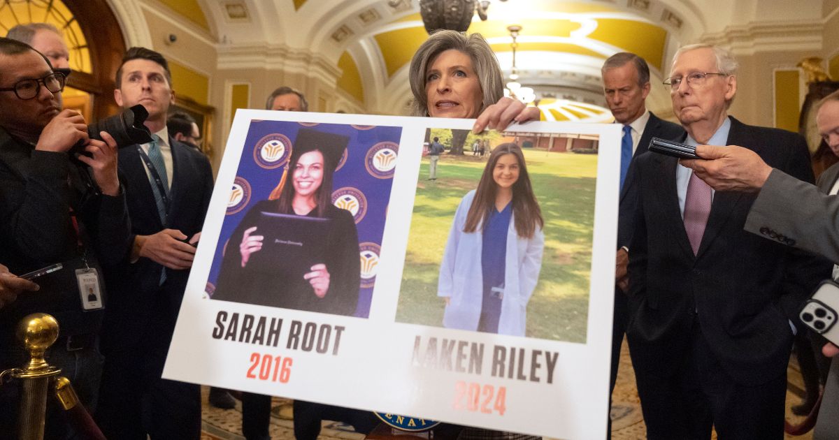 Sen. Joni Ernst, R-Iowa, holds a poster with photos of murder victims Sarah Root and Laken Riley as she speaks on Capitol Hill, Feb. 27 in Washington. House Republicans have passed a bill that would require federal authorities to detain unauthorized immigrants who have been accused of theft, seizing on the recent death of Riley, a nursing student in Georgia. The bill sent a rebuke to President Joe Biden’s border policies just hours ahead of his State of the Union address. However, the nine-page bill had little chance of being taken up in the Democratic-controlled Senate.