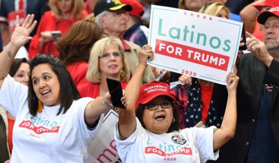 A supporter of then-President Donald Trump hold a sign reading "Latinos for Trump" at a "Keep America Great" rally in Dallas, Texas, in a file photo from October 2019.