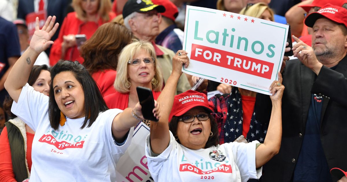 A supporter of then-President Donald Trump hold a sign reading "Latinos for Trump" at a "Keep America Great" rally in Dallas, Texas, in a file photo from October 2019.