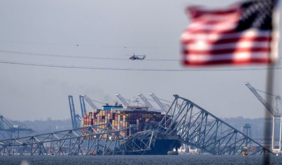 the container ship Dali resting against wreckage of the Francis Scott Key Bridge