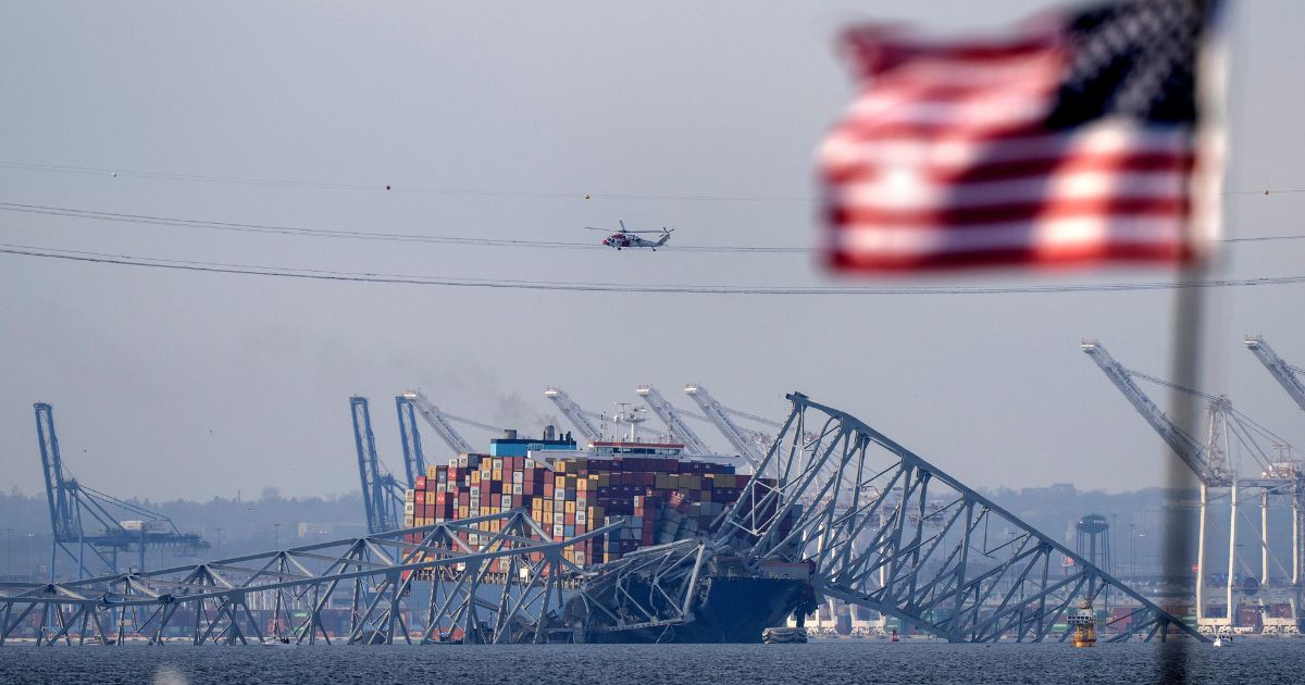 the container ship Dali resting against wreckage of the Francis Scott Key Bridge