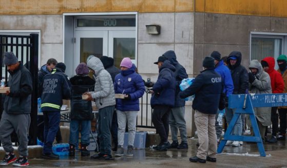 Migrants line up for free food after arriving in Chicago on Jan. 12.