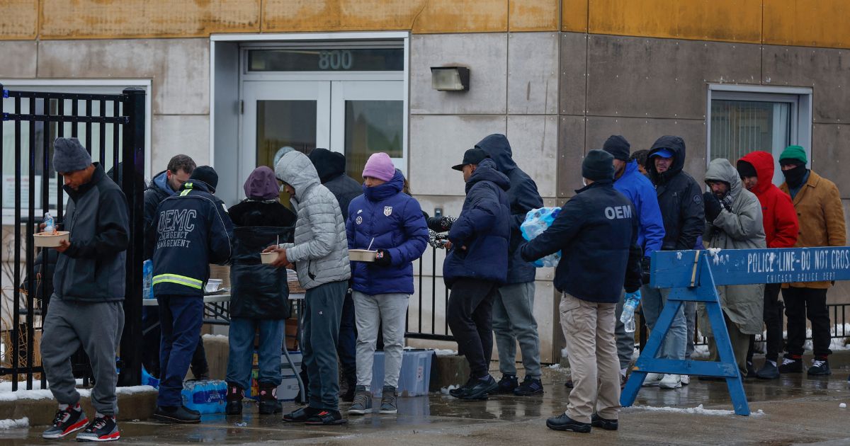 Migrants line up for free food after arriving in Chicago on Jan. 12.
