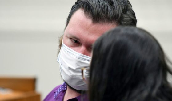 Miles Harford appears in court to hear the charges against him, Friday, in Denver. Harford, a former funeral home owner accused of keeping a woman's corpse in the back of a hearse for two years and hoarding the cremated remains of 35 people, has been charged with forgery, theft and abuse of a corpse.