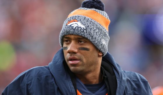 Then-Denver Bronco quarterback Russell Wilson looks on from the sideline during an NFL football game against the Los Angeles Chargers in Denver, Colorado, on Dec. 31.
