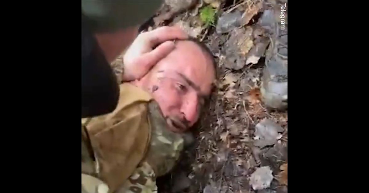 Russian prisoner Saidakrami Rachabalizoda, a suspect in the March 22 terrorist attack, is beaten by soldiers.