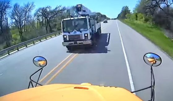 An image taken from a YouTube video shows the moment before a cement truck crashed into a school bus in Texas, killing one child on the bus and another driver on the road.