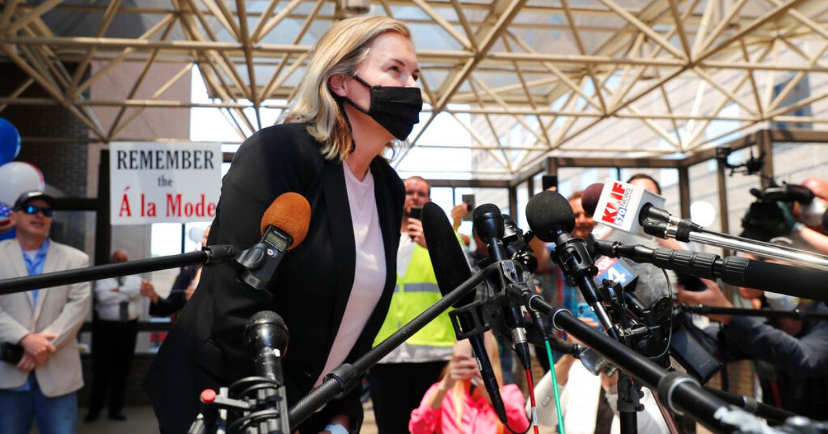 Salon owner Shelley Luther leans in to speak to the media and supporters after she was released from jail in Dallas, May 7, 2020.