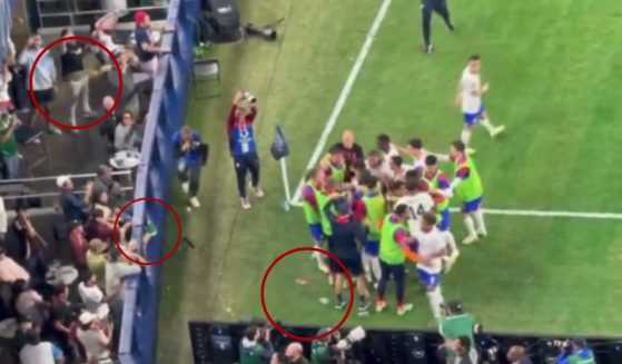 After the U.S. men's soccer team scored their second goal in their game against Mexico on Sunday, Mexican fans threw beer, circled, at them as they gathered to celebrate.