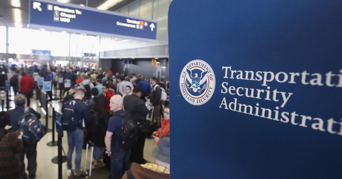 Passengers at O'Hare International Airport in Chicago wait in line to be screened at a Transportation Security Administration checkpoint on May 16, 2016.