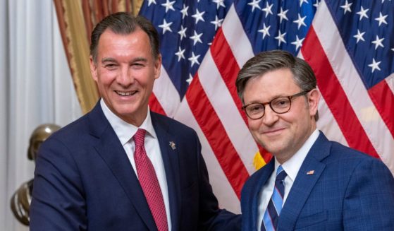 Tom Suozzi shaking hands with Mike Johnson