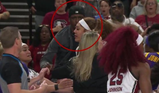 Trayron Milton, circled, was reportedly arrested and faces third-degree assault and battery and disorderly conduct charges after jumping onto the court during Saturday's brawl between the LSU and South Carolina women's basketball teams in the SEC Championship game.