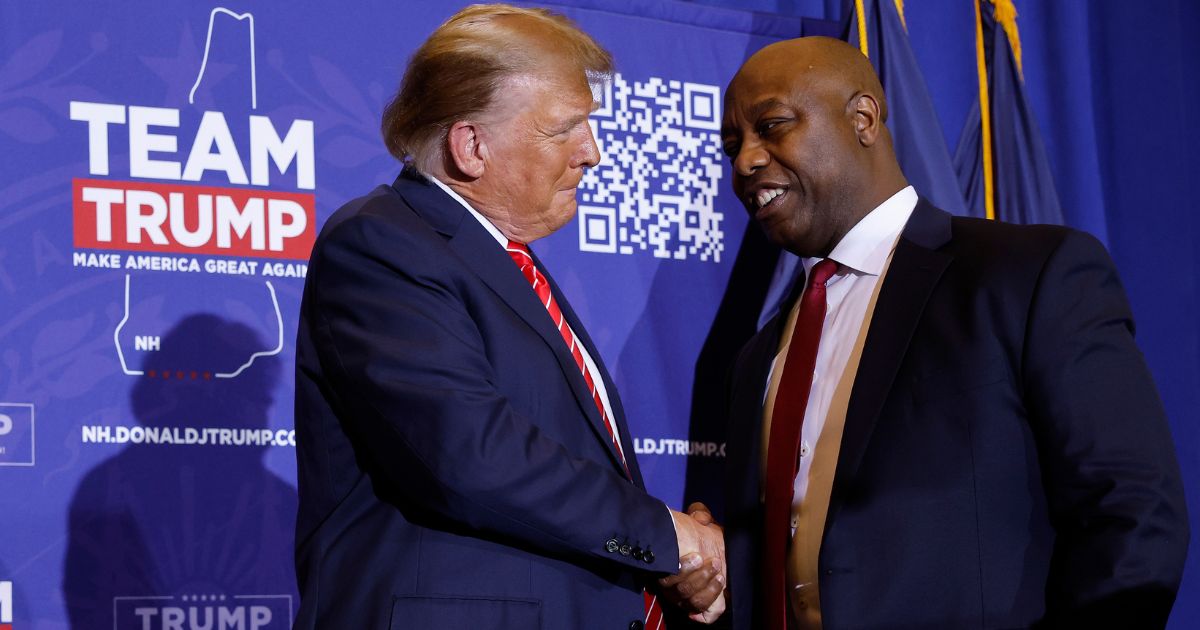 Republican Sen. Tim Scott of South Carolina shakes hands with Republican presidential candidate and former President Donald Trump during a campaign rally at the Grappone Convention Center in Concord, New Hampshire, on Jan. 19.