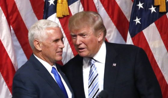 Then-presidential candidate Donald Trump, right, shakes hands with his vice presidential running mate Mike Pence in a file photo from July 2016.