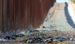 Ashes from a bonfire and clothes are pictured next to the U.S.-Mexico border wall in Sasabe, Arizona, on Dec. 5.
