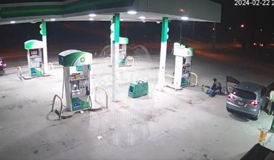 According to Kansas City police, surveillance video at a gas station last month shows a suspect going through the pockets of a man who was lying injured after being shot. The suspect was "looking for valuables,” police said.