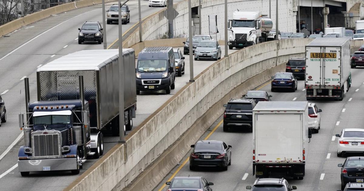 Motor vehicle traffic moves along Interstate 76 in Philadelphia in 2021. The EPA on Friday set new gas emissions standards for heavy-duty trucks, buses and other large vehicles.