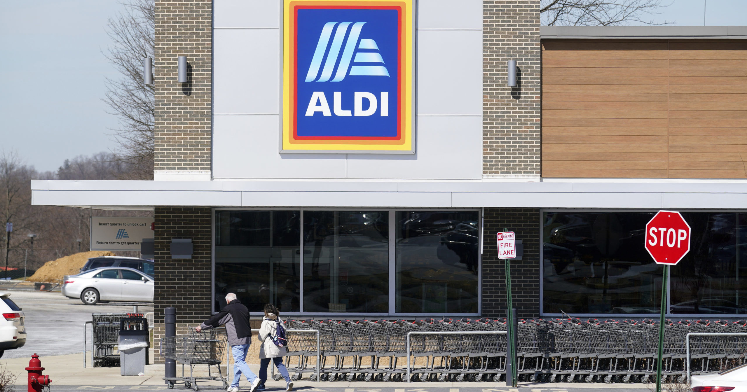 Customers walk into an Aldi supermarket in Bensalem, Pennsylvania, on March 14, 2022.