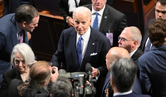 President Joe Biden gladhands after the State of the Union address March 7 in the House of Representatives chamber.