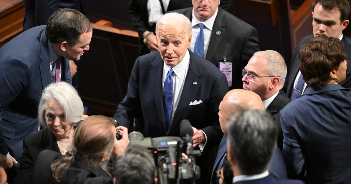 President Joe Biden gladhands after the State of the Union address March 7 in the House of Representatives chamber.
