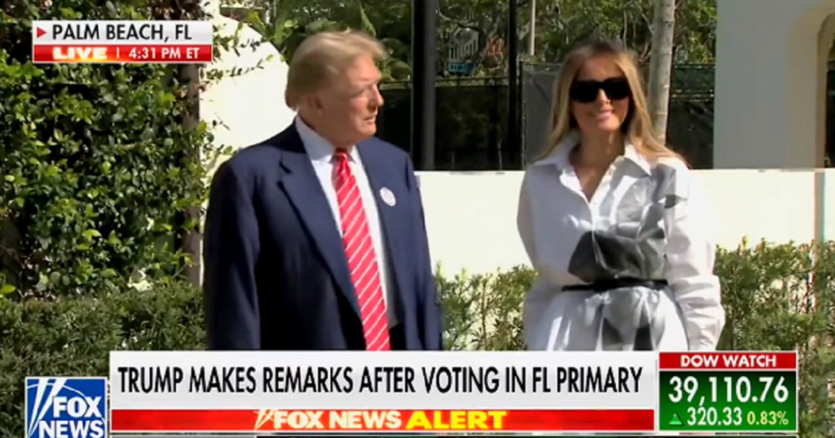 Former first lady Melania Trump smiles as she appears with her husband, former President Donald Trump, outside a polling site in Palm Beach, Florida, on Tuesday.