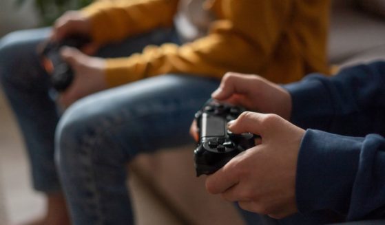This stock image shows two boys playing video games.