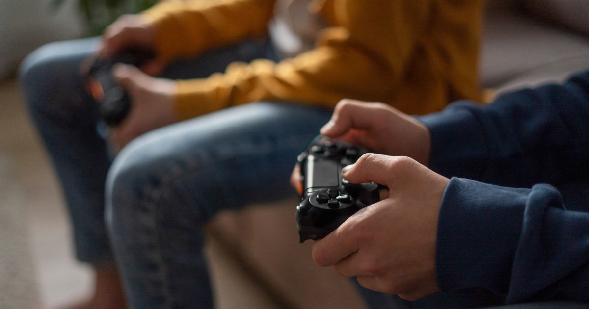 This stock image shows two boys playing video games.