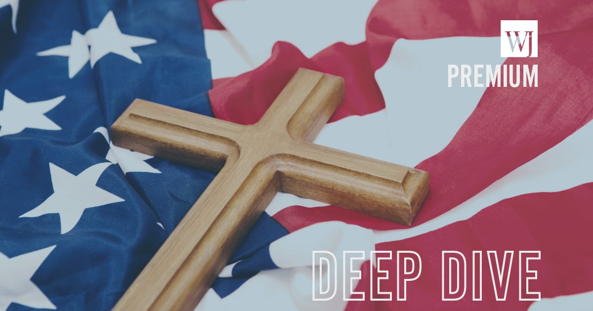 A wooden cross lies on an American flag in this stock image.