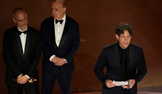 Jonathan Glazer, director of the movie "Zone of Interest" accepts the Oscar for Best International Feature Film on March 10. With Glazer are, from left, producers James Wilson and Leonard Blavatnik.