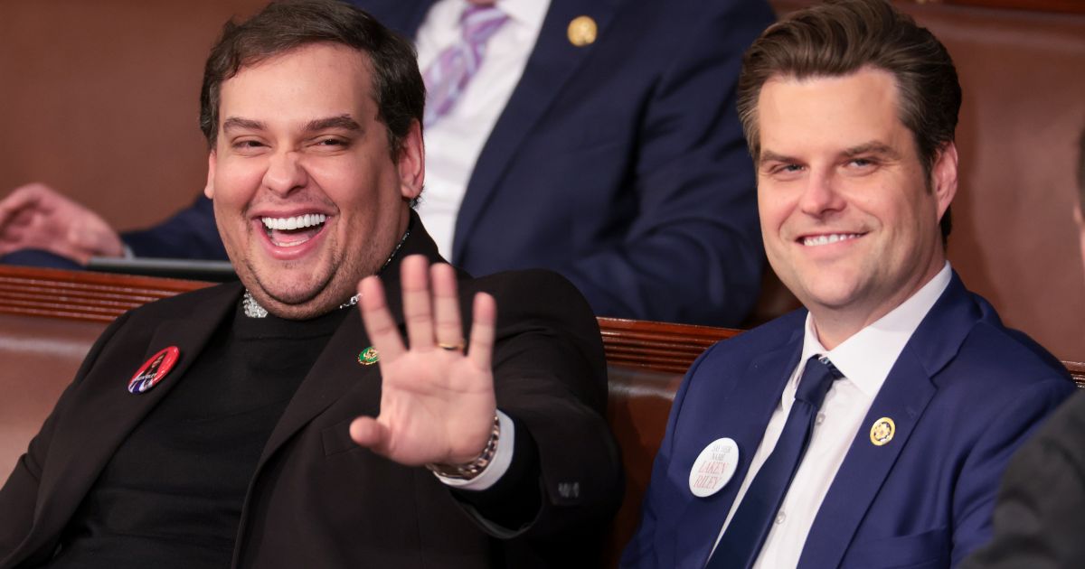 Former Rep. George Santos, left, sits with Rep. Matt Gaetz at President Joe Biden's State of the Union address in the House chamber at the U.S. Capitol on Thursday in Washington, D.C.