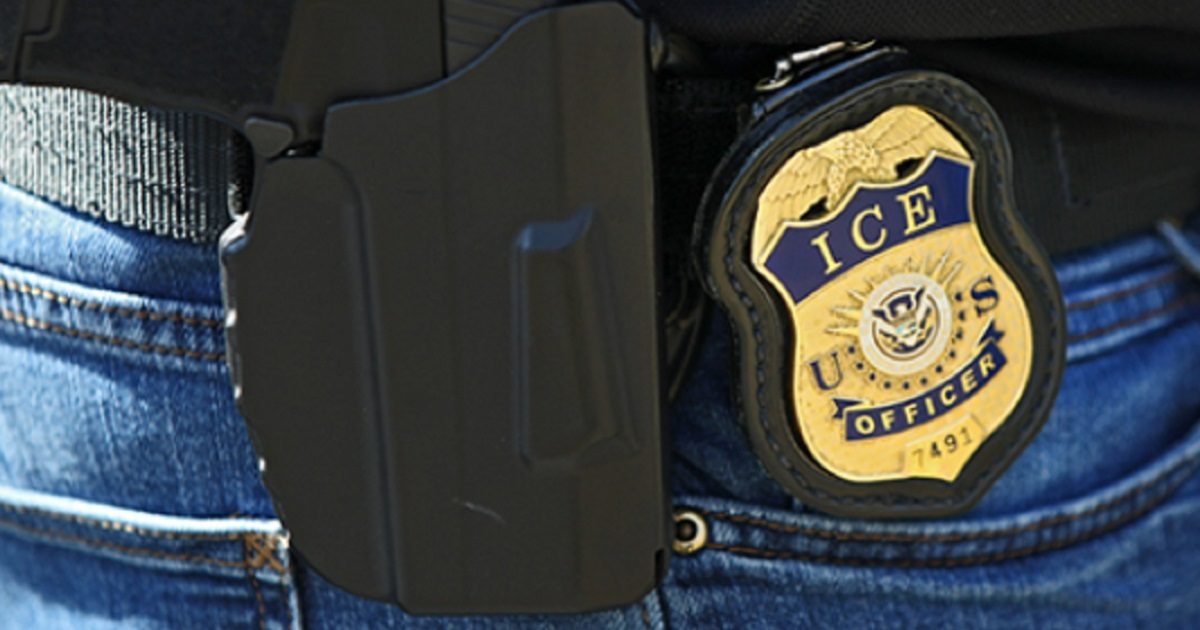 A badge and gun of an Immigration and Customs Enforcement agent.