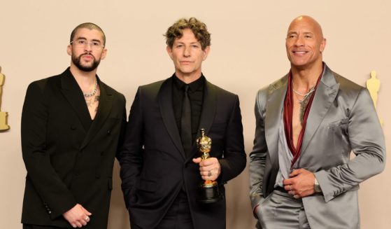Jonathan Glazer (C), winner of the Best International Feature Film award for “The Zone of Interest”, poses with Bad Bunny (L) and Dwayne Johnson (R) in the press room during the 96th Annual Academy Awards at Ovation Hollywood on March 10, 2024 in Hollywood, California.