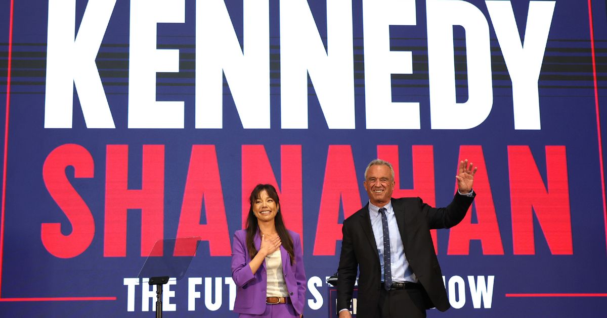 Independent presidential candidate Robert F. Kennedy Jr. and his vice presidential pick Nicole Shanahan take the stage during a campaign event on Tuesday in Oakland, California.
