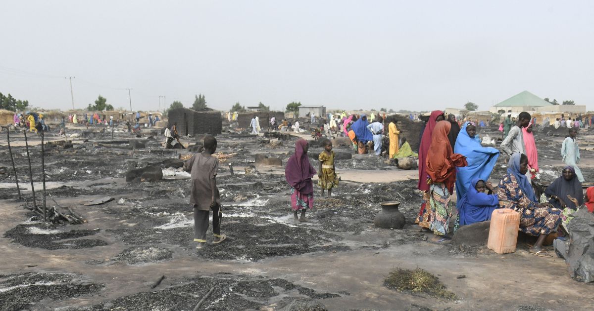Women and children located at a camp for displaced Nigerians near Maiduguri, Nigeria, walk around after a fire tore through the camp on Nov. 15. Recently, at least 200 displaced people were taken by Islamic extremists.