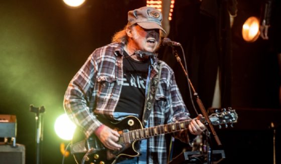 Music star Neil Young performs on stage in an April 2023 file photo from the Autism Speaks Light Up The Blues 6 Concert at The Greek Theatre in Los Angeles.