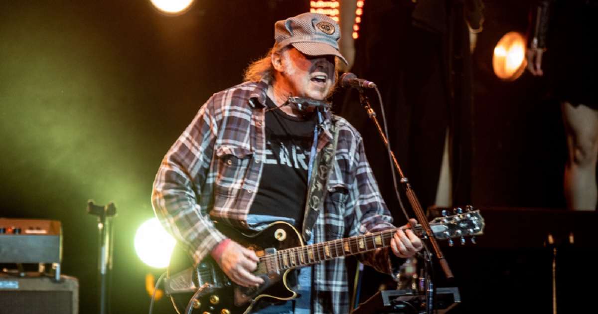Music star Neil Young performs on stage in an April 2023 file photo from the Autism Speaks Light Up The Blues 6 Concert at The Greek Theatre in Los Angeles.