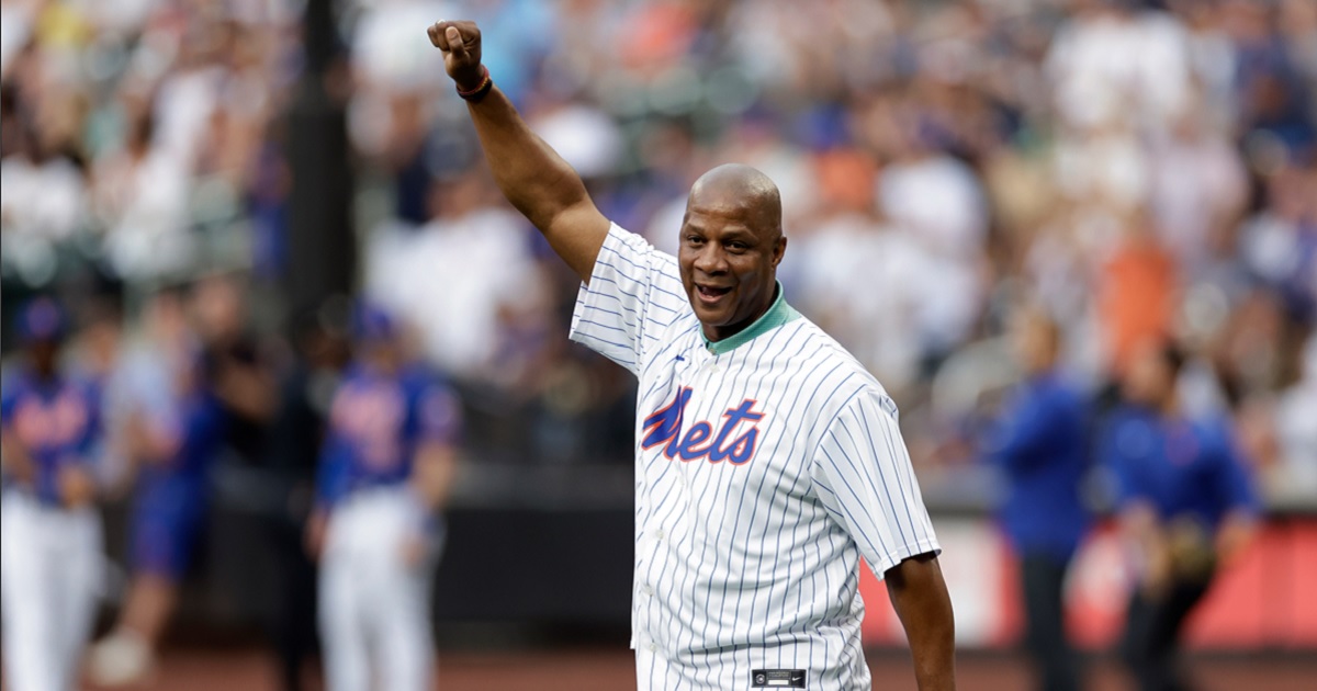 Former New York Met Darryl Strawberry raises his fist in the air after throwinga ceremonial first pitch at Citi Field on July 26, 2022 in New York City.